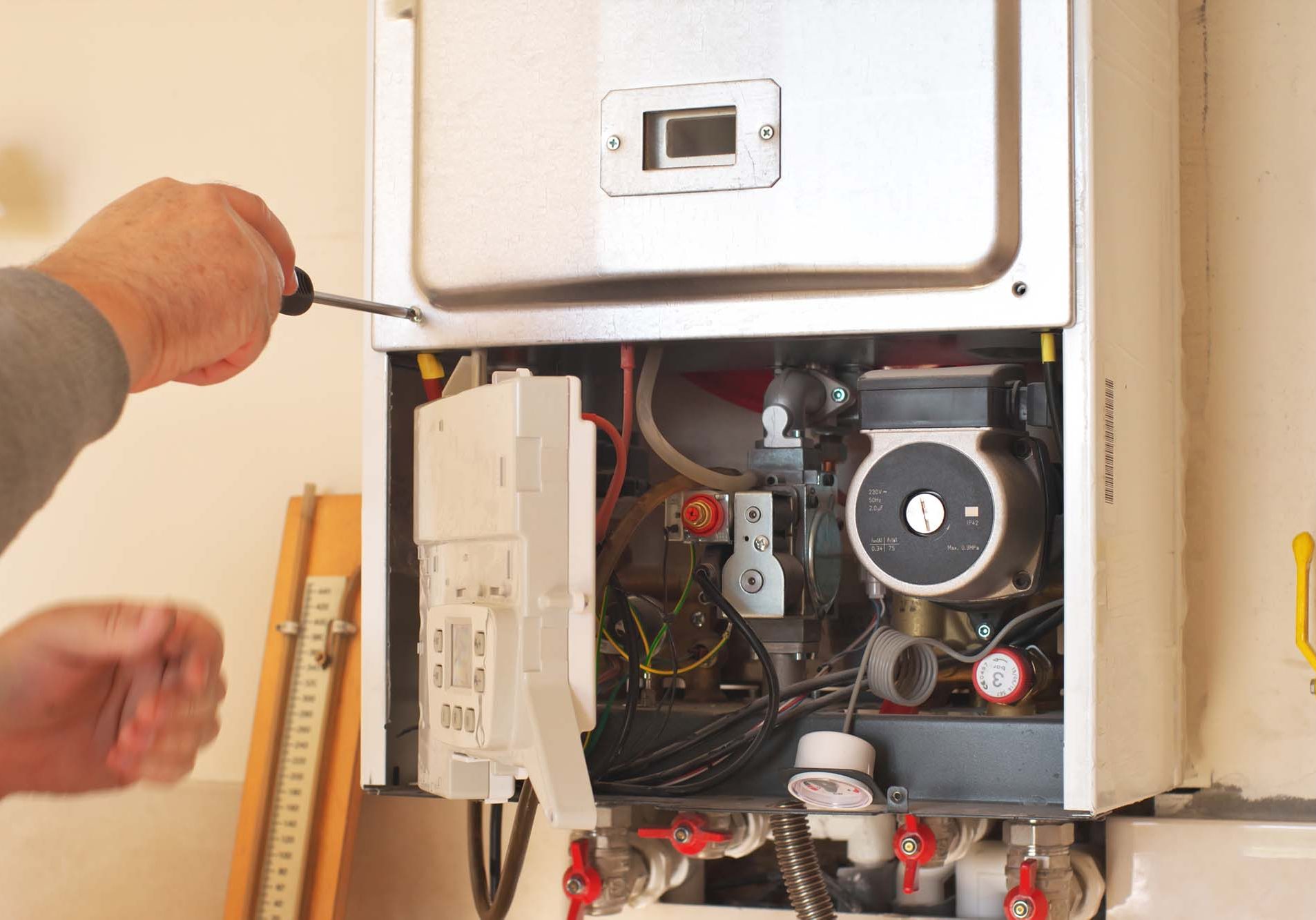 Man servicing a home boiler